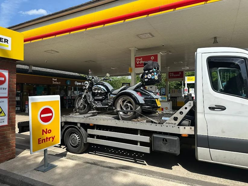 Motorcycle towing at petrol station — Awan Recovery MK