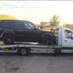 Car being towed by Awan Recovery MK flatbed truck in Milton Keynes
